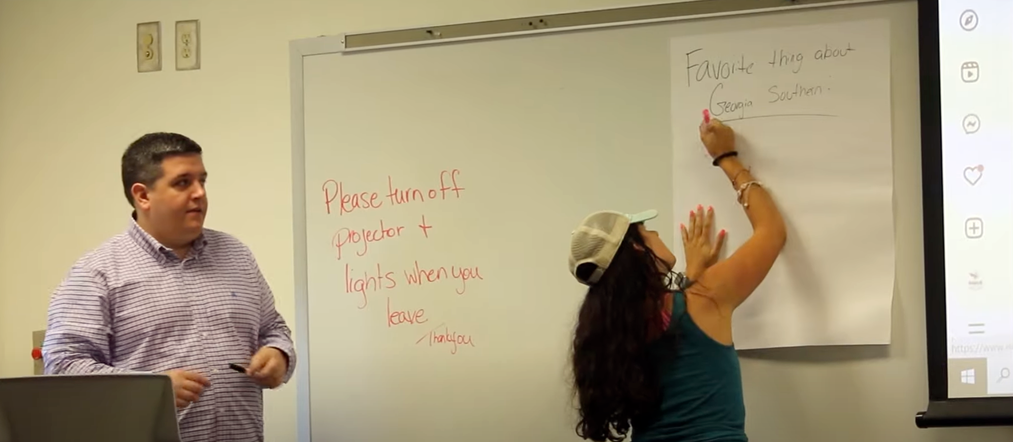 Student writing in whiteboard along teacher