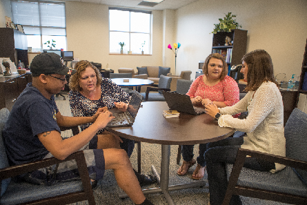 Group of students in a library setting during a study session